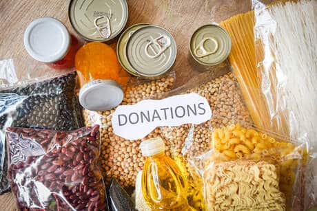 31410284 donations food with canned food on wooden table background pas